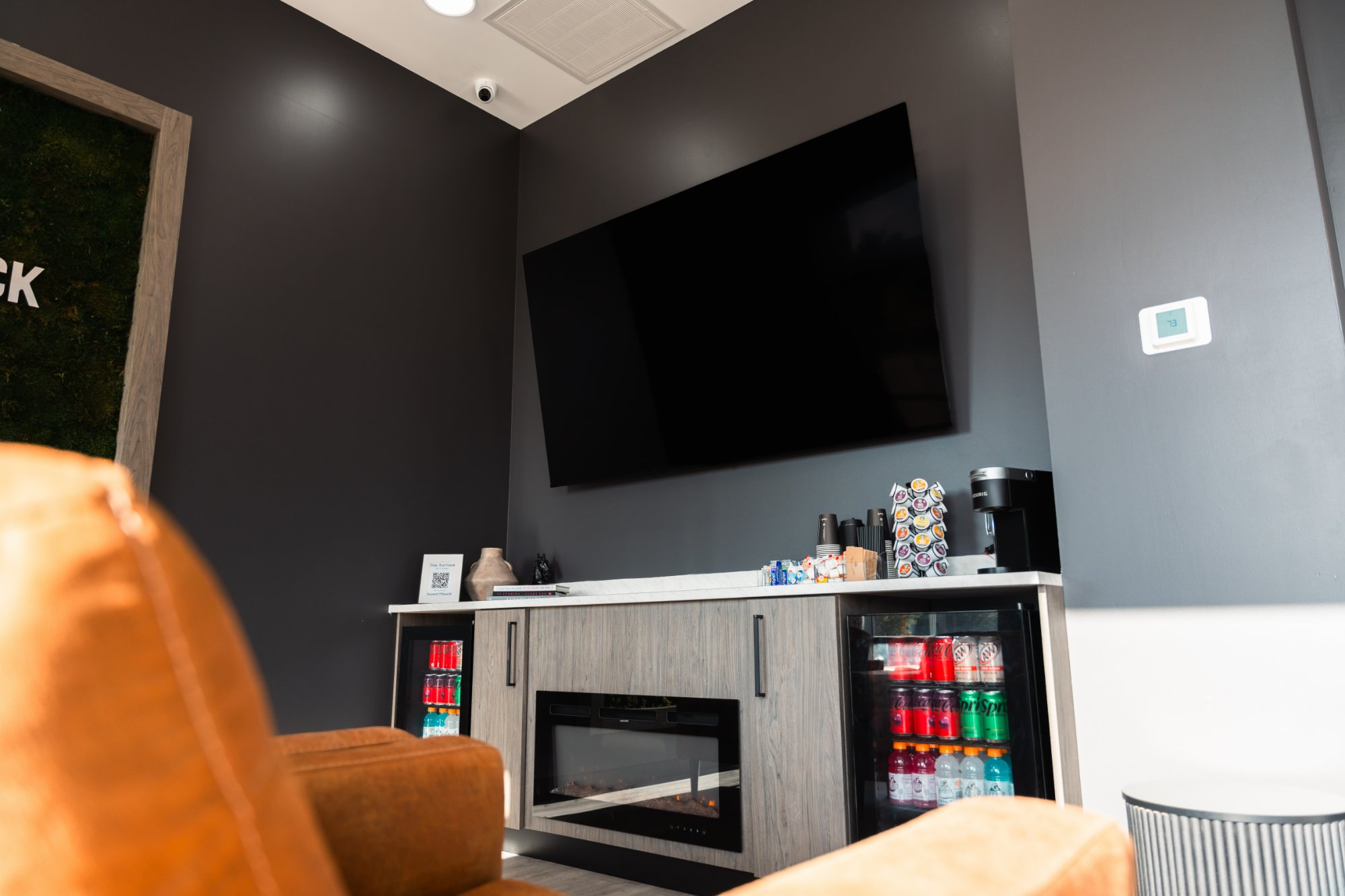 The True Test lounge with a big-screen TV, coffee bar and drinks fridge